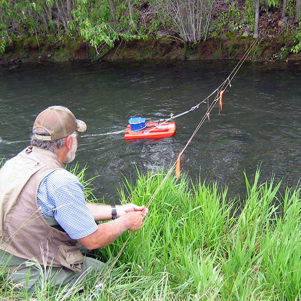man using technical equipment in river